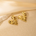 Twisted gold heart-shaped liquid metal earrings on a stone tray with silk - Irregular Heart Shape (0405)