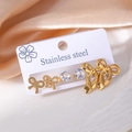 Detailed set of golden stainless steel bow earrings and round crystals on a white display card - Bow Knot Zirconia Set