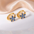 Elegant gold flower earrings with blue cubic zirconia on a luxury silk background - Blue Five-Petal Flower Style (1336)