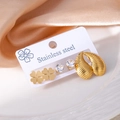 Detailed set of clover, zircon, and textured gold leaf earrings on white display card - Clover Water Drop Zirconia Set