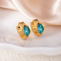 Detailed macro view of gold huggie earrings with oval blue rhinestones on silk fabric - Blue Oval Eye Style (1420)