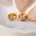 Detailed macro view of heart-cut zircon stone embedded in wide gold hoop earrings - White Heart Style (1426)