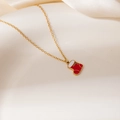 Close-up of a festive Christmas stocking pendant necklace with red and white oil drip finish - Red Christmas Sock Pendant Necklace