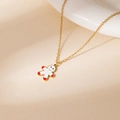 Golden necklace featuring a cute gingerbread man pendant on a warm textured background - Red White Gingerbread Man Necklace