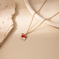 Macro view of Santa sleigh necklace with red enamel and gold chain detail - Santa Sleigh Pendant Necklace