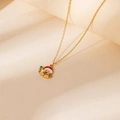 Close-up of golden Christmas snowman necklace with red hat and green star enamel detail - Christmas Snowman Pendant Necklace
