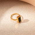 Macro view of adjustable gold ring featuring a rectangular black onyx gemstone inlay - Black Zirconia Rectangle Ring