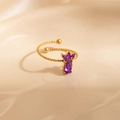 Macro shot of gold twist band ring featuring purple marquise and teardrop stones - Purple Pineapple (1654)