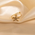 Detailed macro view of a gold-plated starfish ring with zircons on silk background - Starfish Zircon Style (1662)