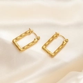 Detail shot of golden bamboo texture rectangular hoop earrings on beige silk fabric - Square Bamboo Joint Earrings 0199