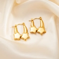 Detail showing two gold star pendants hanging from polished metal hoops on silk background - Double Star Earrings 0279