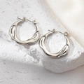 Minimalist silver irregular lava texture hoop earrings on white stone background - Round Irregular Surface Earrings 0201