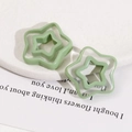Macro view of light green double-layer hollowed star resin DIY jewelry accessories - Green Five-point Star