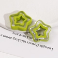 Macro shot of colorful hollow star resin charms for DIY earrings and hair accessories - Dark Green Star