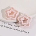 Macro shot of pink double-layered star resin charms for DIY earring and hair jewelry - Nude Pink Star