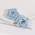Detail shot of light blue resin hollow star pendants for DIY earring making - Blue Pentagram