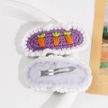 Detail of handmade purple knitted hair clips featuring orange carrot embroidery - Purple