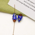 Macro shot of colorful mushroom glass beads for DIY jewelry making with blue and green texture - Sapphire Blue