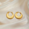 Polished golden twist hoop earrings with spiral texture on elegant beige silk fabric - Diagonal Round Hoop Earrings 0178