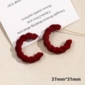 Detail view of red flocked C-shape twisted hoop earrings sized 37mm by 31mm - Twisted C-Shape (No. 3)