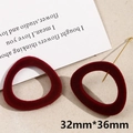 Close-up of burgundy flocked triangular earring pendant with gold pins on a beige surface - Irregular (#5, 1 Piece)