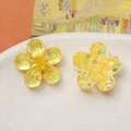 Macro shot of yellow translucent flower charms with iridescent sequins for jewelry DIY - Bright Yellow Flower
