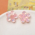 Close-up of pink translucent resin flower charms with iridescent sequins for DIY crafts - Light Pink Flower