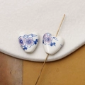 Macro shot of heart-shaped ceramic bead with hand-painted purple flowers and leaf patterns - Blue & Pink-Purple Floral Style (Pattern 17) / 1 Piece