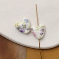 Macro detail of heart-shaped ceramic beads with hand-painted floral patterns for DIY jewelry - Colorful Pastoral Floral Style (Pattern 4) / 1 Piece