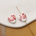 Macro shot of heart-shaped ceramic beads with red flower patterns and gold needles - Red Hand-Drawn Floral Style (Pattern 2) / 1 Piece