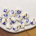Close-up of hand-painted white ceramic flower beads with blue and gold floral patterns - Blue Yellow (4#)
