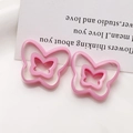 Detail of pink resin butterfly charms with double-layer hollow design and polished finish - Pink Butterfly