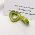 Detail of translucent green resin heart rings featuring hollow and wide-band designs - Fruit Green Heart