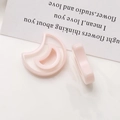 Macro detail of light pink moon-shaped resin charms for DIY earring jewelry making - Light Pink Crescent Moon