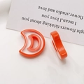 Macro view of orange resin crescent moon charms showing smooth edges and hollow design - Crescent Style (5164756577420) / Orange