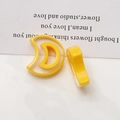 Macro shot of two yellow crescent moon resin DIY jewelry charms for earrings - Yellow Crescent Moon