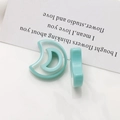 Macro view of mint green resin crescent moon charms for DIY earrings and jewelry making - Lake Green Crescent Moon