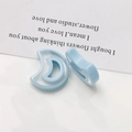 Macro detail of two light blue translucent crescent moon resin earring pendants - Crescent Style (5164756577423) / Light Blue