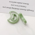 Macro detail of crescent moon resin jewelry components in translucent grass green - Dark Green Crescent Moon