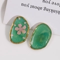 Macro detail of oval green resin earrings featuring pink dried flowers and white pearls - Pearl Green With Pink Flower