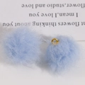 Macro view of a soft light blue faux fur pompom with a gold metal loop for DIY jewelry - Light Blue