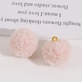 Macro view of fluffy pink faux fur pom-pom charms with gold metal rings for DIY jewelry - Fluffy Light Pink