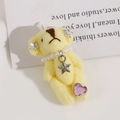 Dettaglio di ciondolo orsetto di peluche giallo con collana di perle e gemma a cuore rosa - Giallo