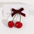 Detail of red velvet bow and cherry accessory on a minimalist white card background - Wine Red Bow Cherry