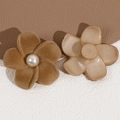 Macro detail of flocked brown flower charm with pearl center and reverse attachment site - Coffee