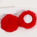 Macro detail of 50mm red faux rabbit fur pom-poms showing fluffy texture and felt backing - Red