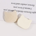 Detail of cream flocked cat head charms showing soft texture and flat back for DIY - Off White