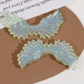 Macro shot of glittery cyan angel wings made of resin with starry blue sparkling powder - Green