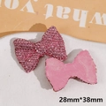 Detailed view of pink resin bow DIY charm with shiny rhinestones, size 28mm x 38mm - Bow / Pink