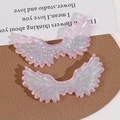 Detailed view of pink glitter acrylic angel wings charms for DIY craft jewelry making - Pink